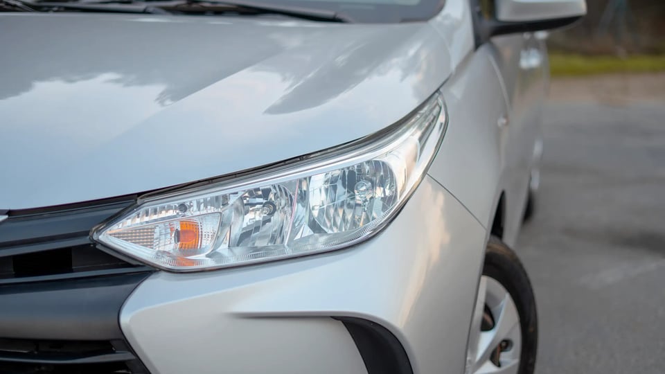 Used 2022 Toyota Yaris E in Silver – Headlight Close-up for Sale at First Choice Cars Dubai Sharjah