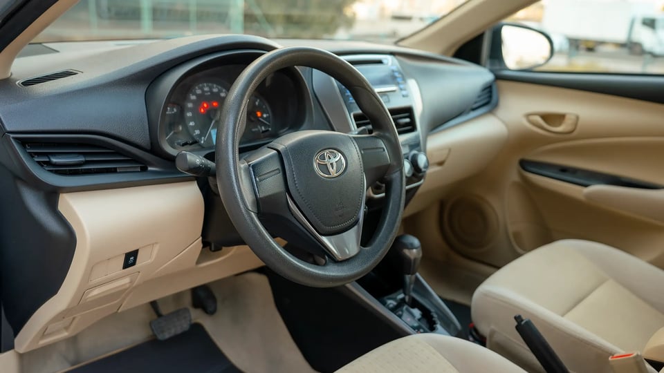 Used 2022 Toyota Yaris E in Silver – Driver Side Dashboard & Steering View for Sale at First Choice Cars Dubai Sharjah
