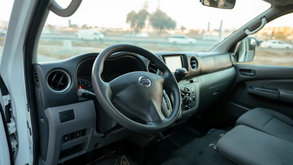 Used 2022 Nissan Urvan High Roof in White – Driver Side Dashboard & Steering View for Sale at First Choice Cars Dubai Sharjah