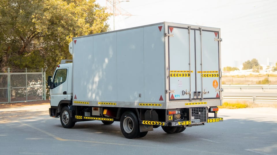 Used 2020 Mitsubishi Canter Chiller Box in White – Left Back Diagonal (45°) View for Sale at First Choice Cars Dubai Sharjah
