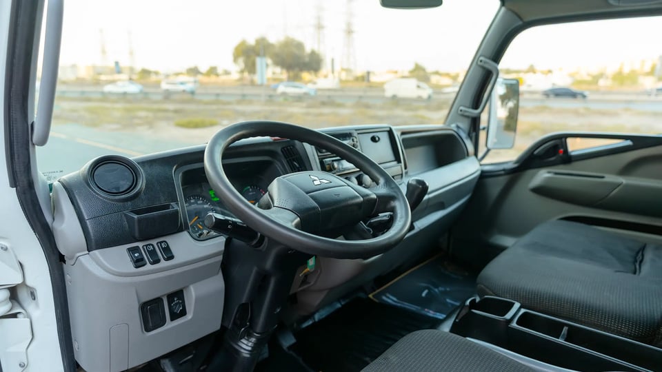 Used 2020 Mitsubishi Canter Chiller Box in White – Driver Side Dashboard & Steering View for Sale at First Choice Cars Dubai Sharjah