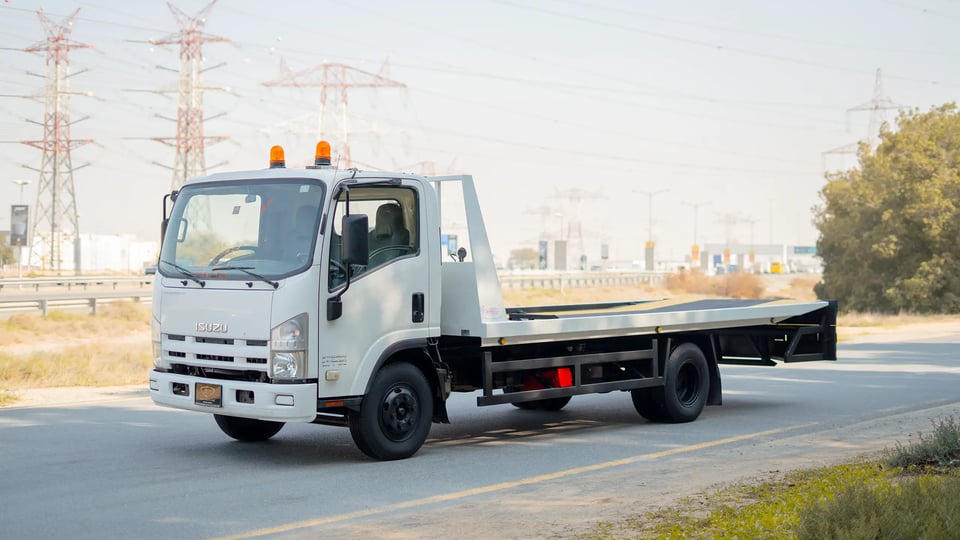 Used 2017 Isuzu NPR Recovery in White – Left Front Diagonal (45°) View for Sale at First Choice Cars Dubai Sharjah