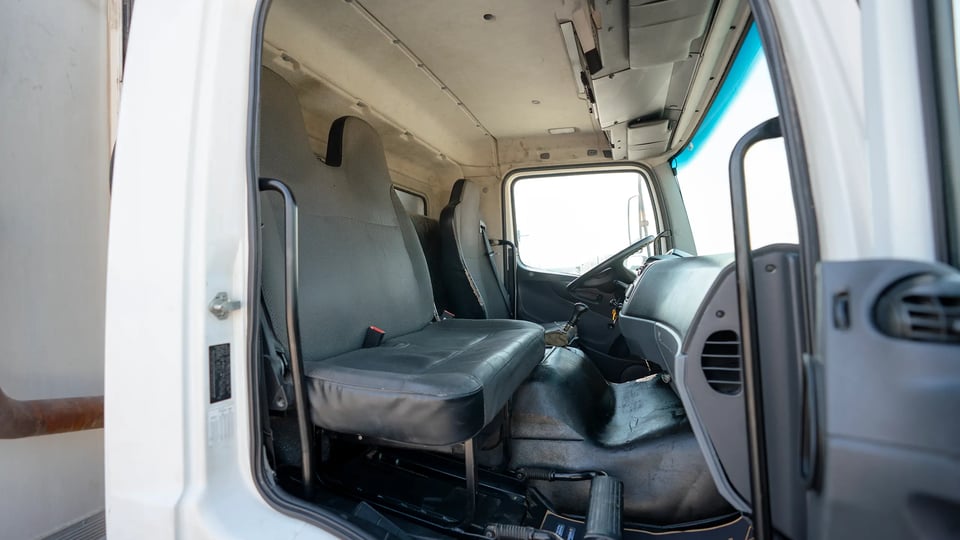 Used 2020 Mitsubishi Fuso FJ Freezer Box in White – Front Passenger Side Cabin View for Sale at First Choice Cars Dubai Sharjah