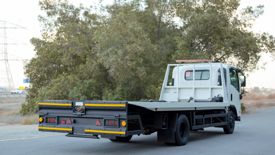 Used 2017 Isuzu NPR Recovery in White – Right Back Diagonal (45°) View for Sale at First Choice Cars Dubai Sharjah