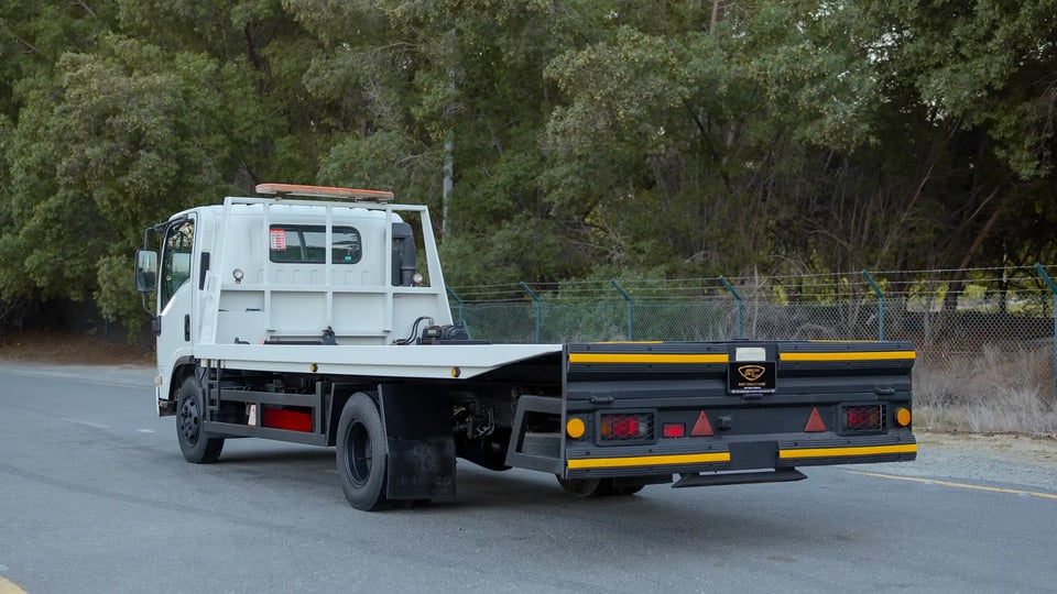 Used 2017 Isuzu NPR Recovery in White – Left Back Diagonal (45°) View for Sale at First Choice Cars Dubai Sharjah