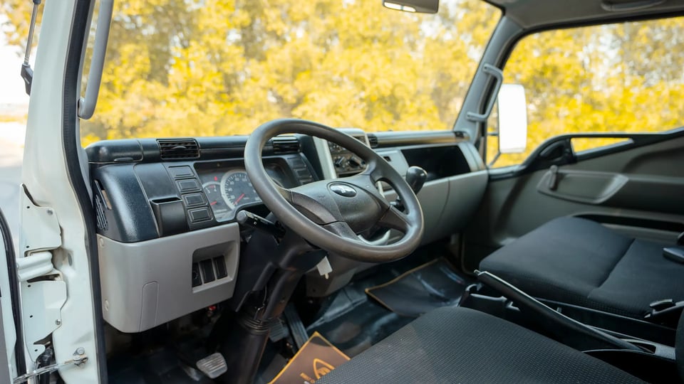 Used 2017 Mitsubishi Canter Cargo Body in White – Driver Side Dashboard & Steering View for Sale at First Choice Cars Dubai Sharjah