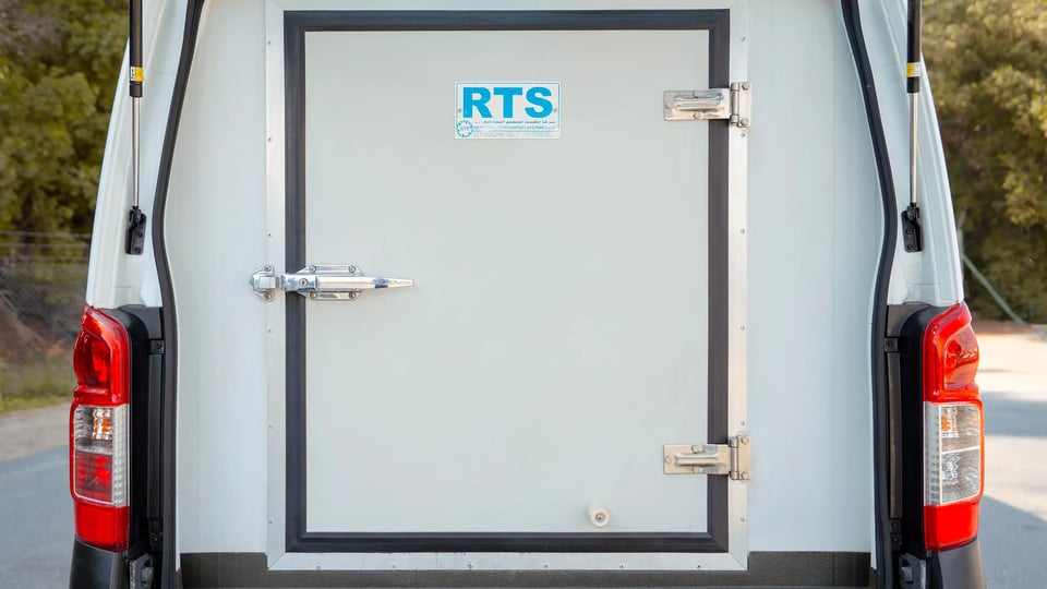 Used 2020 Nissan Urvan Standard Roof in White – Rear – Airtight Freezer Door – Straight Rear View for Sale at First Choice Cars Dubai Sharjah