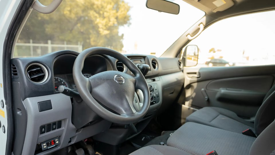 Used 2020 Nissan Urvan Standard Roof in White – Driver Side Dashboard & Steering View for Sale at First Choice Cars Dubai Sharjah