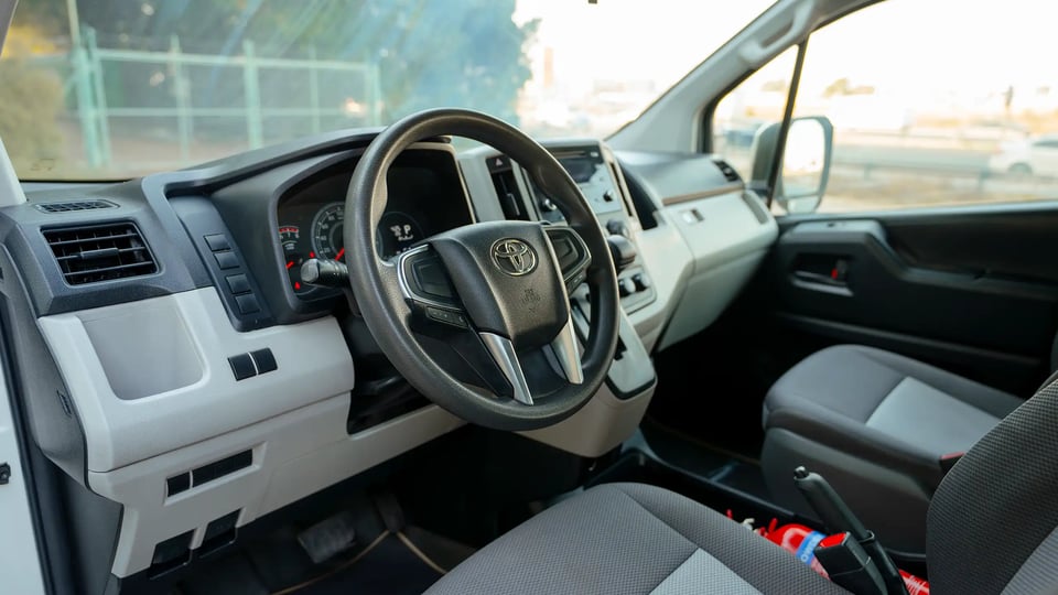 Used 2021 Toyota Hiace GL High Roof in White – Driver Side Dashboard & Steering View for Sale at First Choice Cars Dubai Sharjah