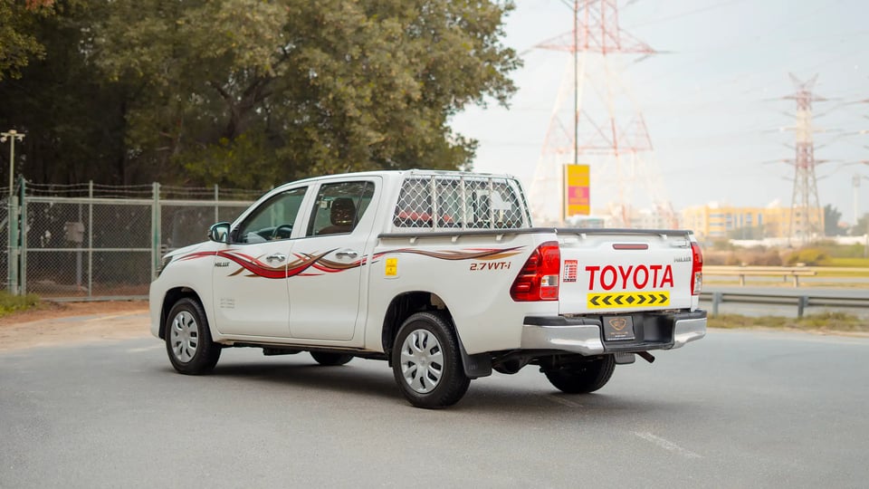 Used 2021 Toyota Hilux GLX Double Cabin in White – Left Back Diagonal (45°) View for Sale at First Choice Cars Dubai Sharjah