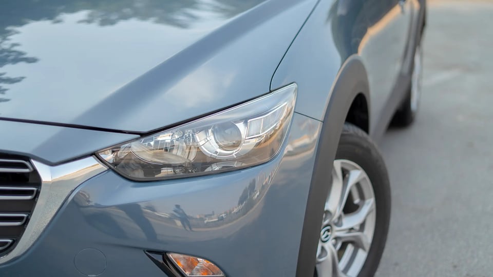 Used 2023 Mazda CX-3 GS in Blue – Headlight Close-up for Sale at First Choice Cars Dubai Sharjah