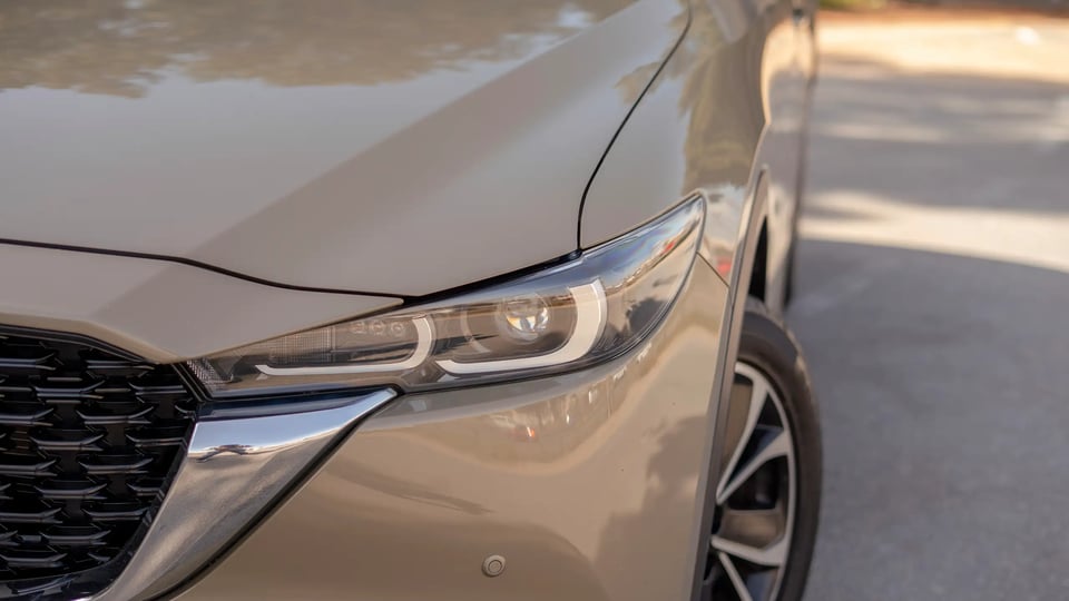 Used 2023 Mazda CX-5 GT in Gold – Headlight Close-up for Sale at First Choice Cars Dubai Sharjah