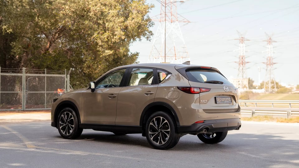 Used 2023 Mazda CX-5 GT in Gold – Left Back Diagonal (45°) View for Sale at First Choice Cars Dubai Sharjah