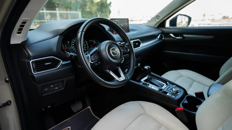 Used 2023 Mazda CX-5 GT in Gold – Driver Side Dashboard & Steering View for Sale at First Choice Cars Dubai Sharjah