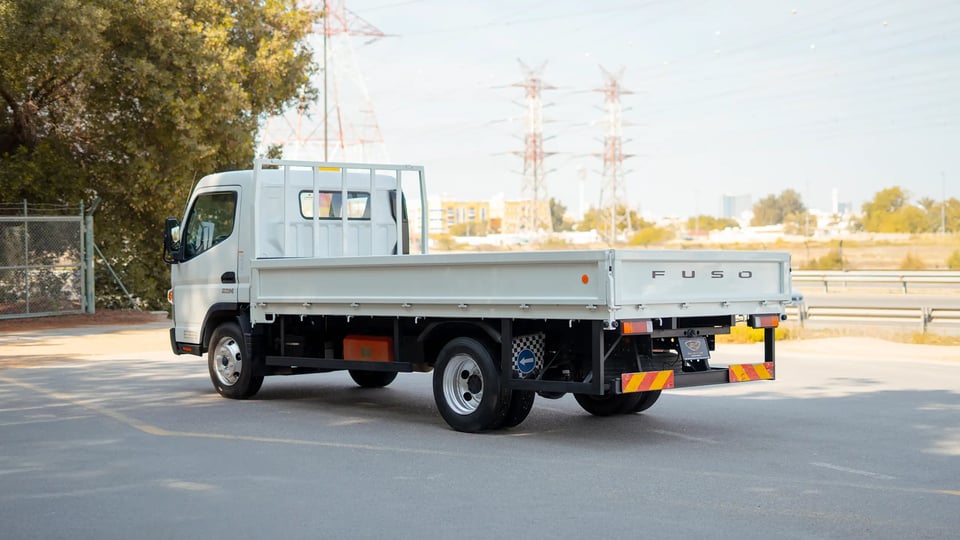 Used 2023 Mitsubishi Canter Cargo Body in White – Left Back Diagonal (45°) View for Sale at First Choice Cars Dubai Sharjah
