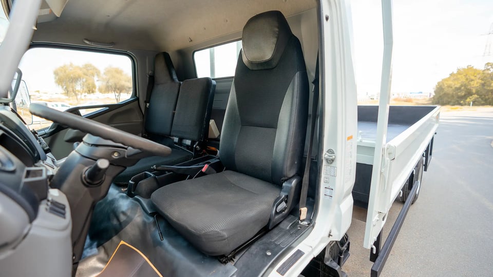 Used 2023 Mitsubishi Canter Cargo Body in White – Front Driver Side Cabin View for Sale at First Choice Cars Dubai Sharjah