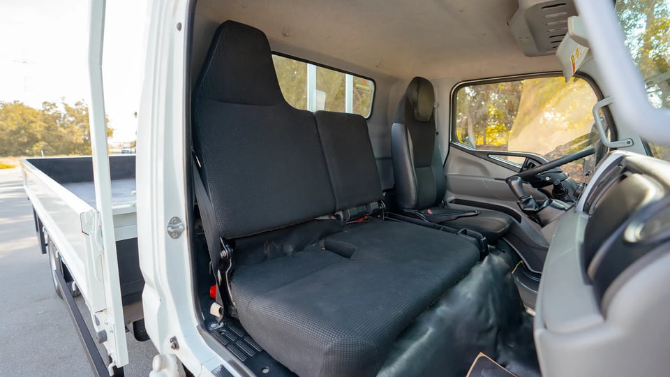 Used 2023 Mitsubishi Canter Cargo Body in White – Front Passenger Side Cabin View for Sale at First Choice Cars Dubai Sharjah