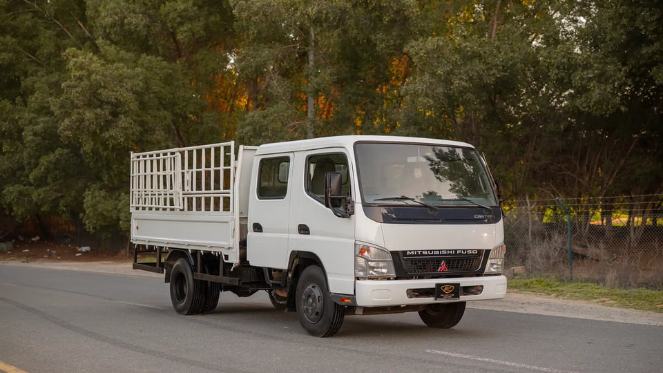 Used 2006 Mitsubishi Canter Double Cabin Cargo Body in White – Right Front Diagonal (45°) View for Sale at First Choice Cars Dubai Sharjah