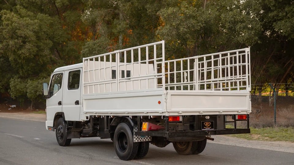 Used 2006 Mitsubishi Canter Double Cabin Cargo Body in White – Left Back Diagonal (45°) View for Sale at First Choice Cars Dubai Sharjah