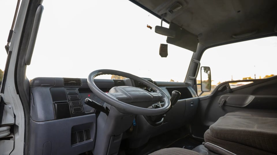 Used 2006 Mitsubishi Canter Double Cabin Cargo Body in White – Driver Side Dashboard & Steering View for Sale at First Choice Cars Dubai Sharjah