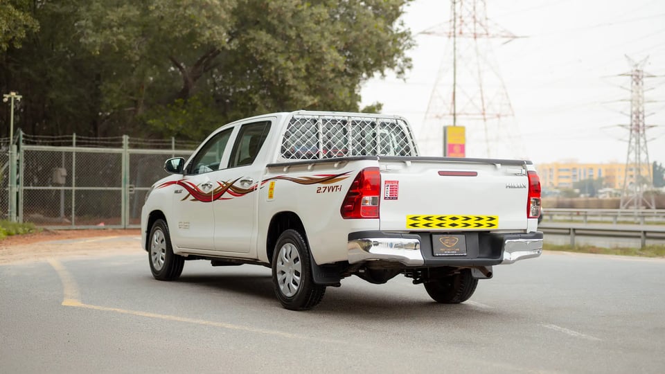 Used 2021 Toyota Hilux GLX Double Cabin in White – Left Back Diagonal (45°) View for Sale at First Choice Cars Dubai Sharjah