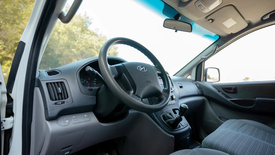 Used 2021 Hyundai H1 Cargo Van in White – Driver Side Dashboard & Steering View for Sale at First Choice Cars Dubai Sharjah