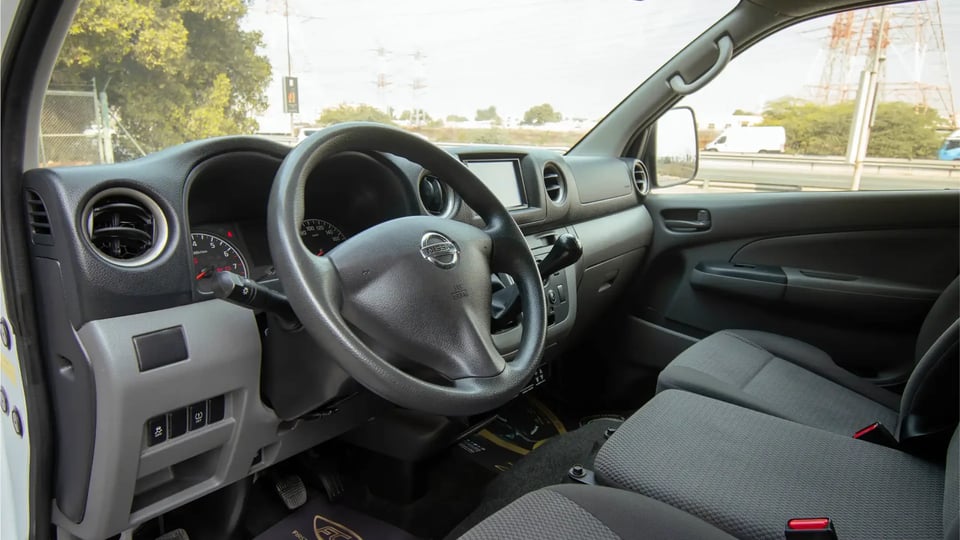 Used 2021 Nissan Urvan Standard Roof in White – Driver Side Dashboard & Steering View for Sale at First Choice Cars Dubai Sharjah
