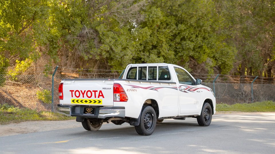 Used 2022 Toyota Hilux GLX Single Cabin in White – Right Back Diagonal (45°) View for Sale at First Choice Cars Dubai Sharjah