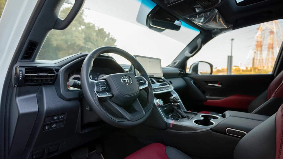 Used 2025 Toyota Land Cruiser VXR in White – Driver Side Dashboard & Steering View for Sale at First Choice Cars Dubai Sharjah