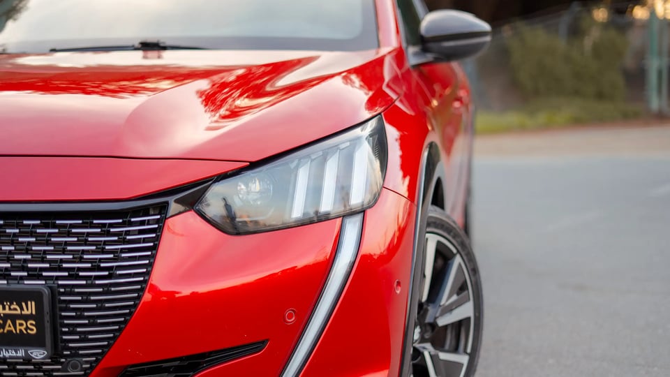 Used 2023 Peugeot 208 GT in Red – Headlight Close-up for Sale at First Choice Cars Dubai Sharjah
