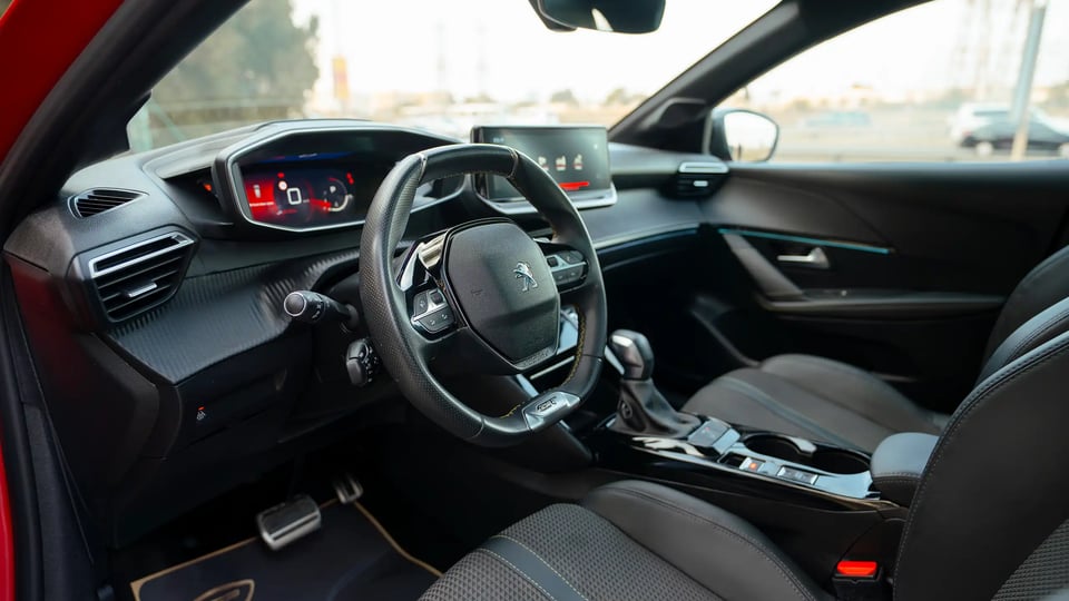 Used 2023 Peugeot 208 GT in Red – Driver Side Dashboard & Steering View for Sale at First Choice Cars Dubai Sharjah