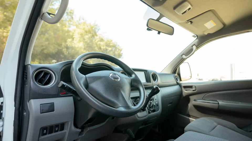 Used 2022 Nissan Urvan Standard Roof in White – Driver Side Dashboard & Steering View for Sale at First Choice Cars Dubai Sharjah