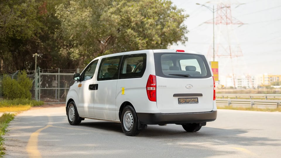 Used 2021 Hyundai H1 12-Seater Wagon in White – Left Back Diagonal (45°) View for Sale at First Choice Cars Dubai Sharjah