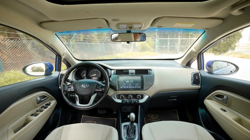 Used 2015 Kia Rio EX in Blue – Front Cabin / Dashboard Full View for Sale at First Choice Cars Dubai Sharjah