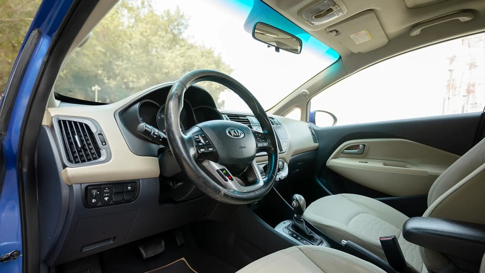 Used 2015 Kia Rio EX in Blue – Driver Side Dashboard & Steering View for Sale at First Choice Cars Dubai Sharjah