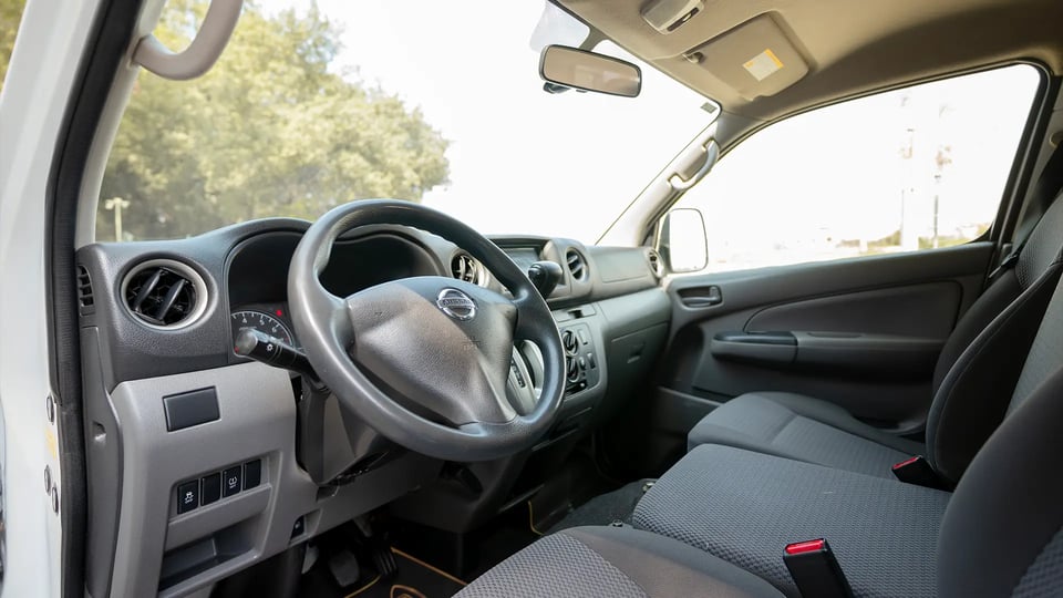 Used 2022 Nissan Urvan Standard Roof in White – Driver Side Dashboard & Steering View for Sale at First Choice Cars Dubai Sharjah