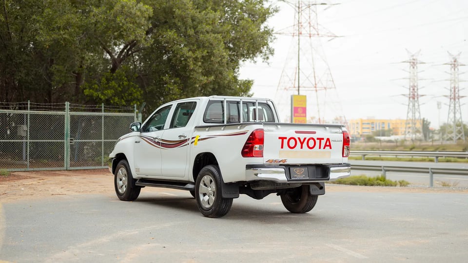 Used 2019 Toyota Hilux DLX Double Cabin in White – Left Back Diagonal (45°) View for Sale at First Choice Cars Dubai Sharjah