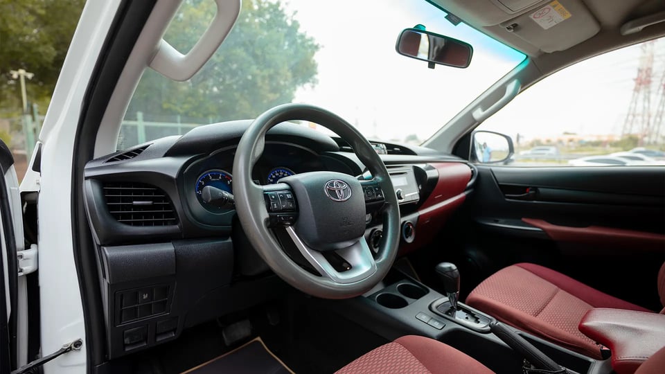 Used 2019 Toyota Hilux DLX Double Cabin in White – Driver Side Dashboard & Steering View for Sale at First Choice Cars Dubai Sharjah