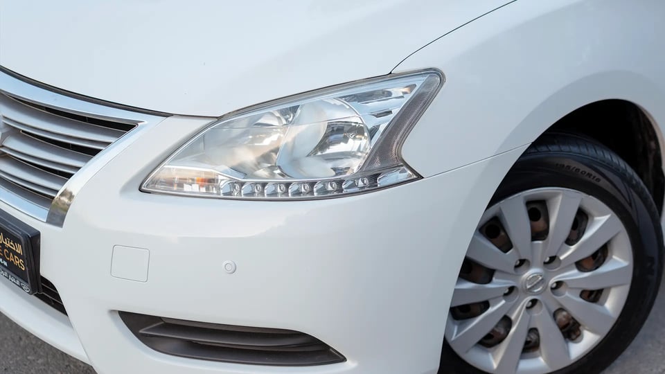 Used 2019 Nissan Sentra S in White – Headlight Close-up for Sale at First Choice Cars Dubai Sharjah