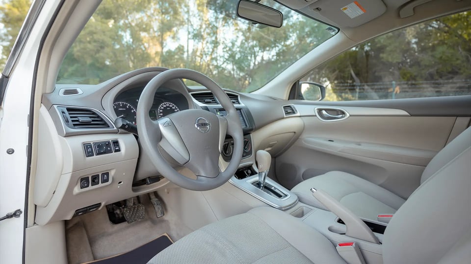 Used 2019 Nissan Sentra S in White – Driver Side Dashboard & Steering View for Sale at First Choice Cars Dubai Sharjah
