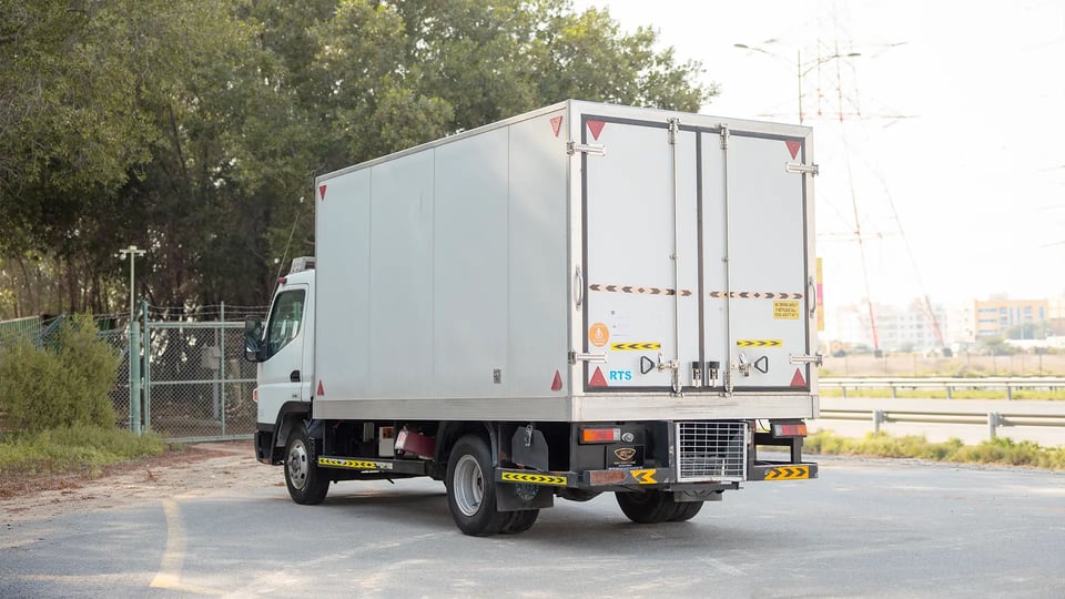Used 2020 Mitsubishi Canter Chiller Box in White – Left Back Diagonal (45°) View for Sale at First Choice Cars Dubai Sharjah
