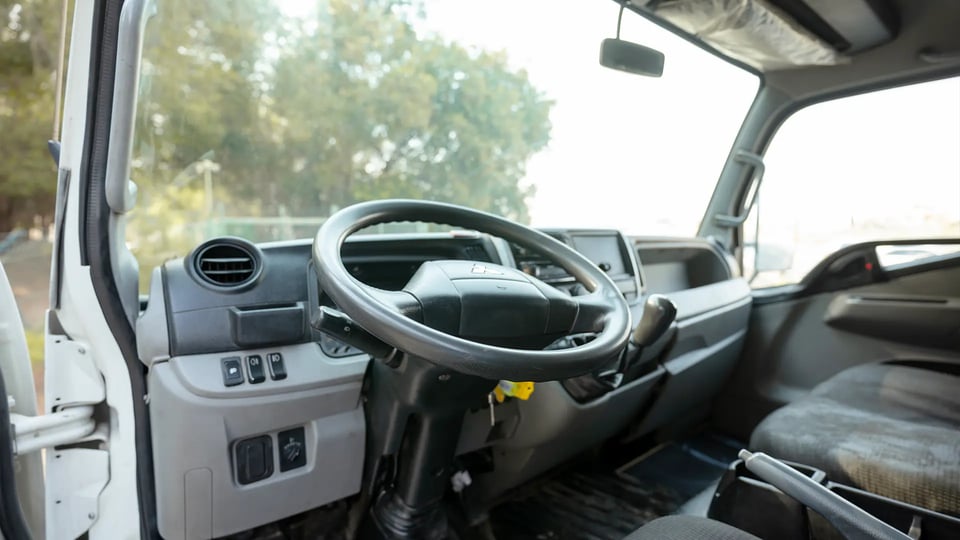 Used 2020 Mitsubishi Canter Chiller Box in White – Driver Side Dashboard & Steering View for Sale at First Choice Cars Dubai Sharjah