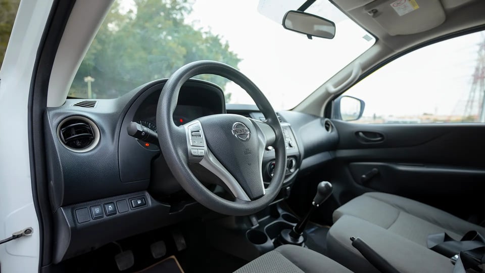 Used 2022 Nissan Navara SE in White – Driver Side Dashboard & Steering View for Sale at First Choice Cars Dubai Sharjah