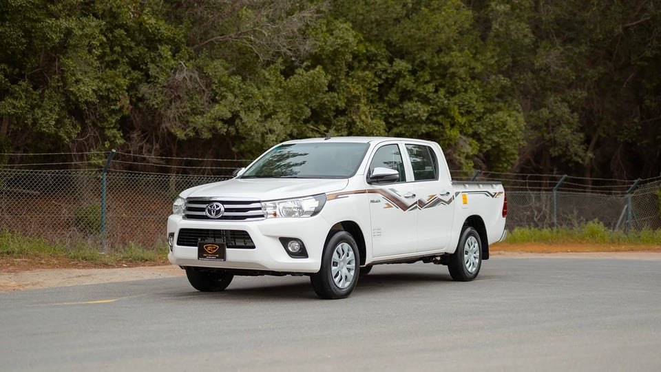 Used 2024 Toyota Hilux GL Double Cabin in White – Left Front Diagonal (45°) View for Sale at First Choice Cars Dubai Sharjah