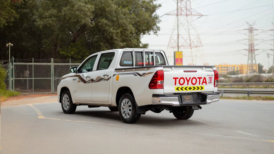 Used 2024 Toyota Hilux GL Double Cabin in White – Left Back Diagonal (45°) View for Sale at First Choice Cars Dubai Sharjah