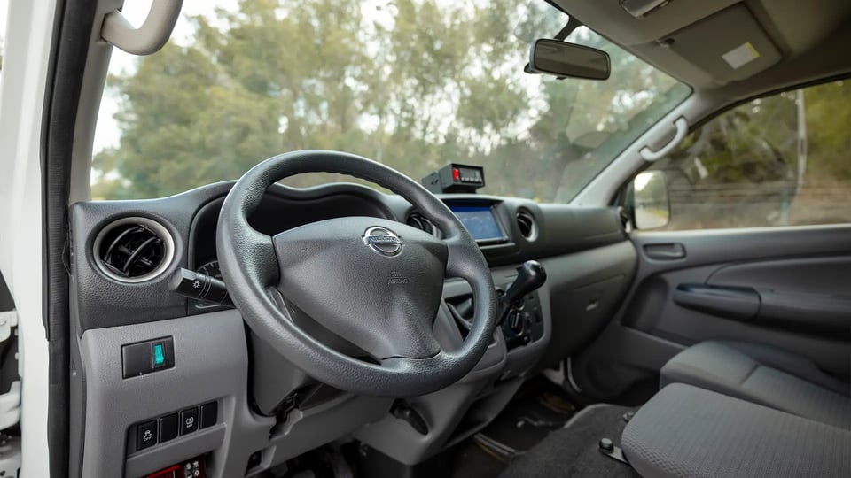 Used 2022 Nissan Urvan High Roof in White – Driver Side Dashboard & Steering View for Sale at First Choice Cars Dubai Sharjah