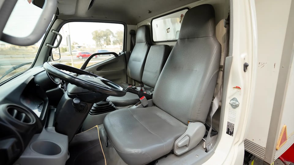 Used 2019 Hino 300 Dry Box in White – Front Driver Side Cabin View for Sale at First Choice Cars Dubai Sharjah
