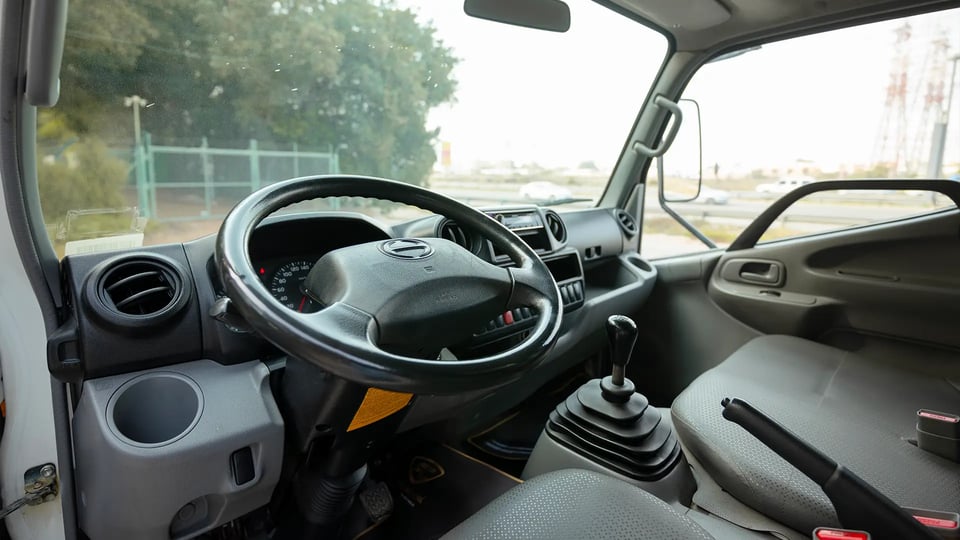 Used 2019 Hino 300 Dry Box in White – Driver Side Dashboard & Steering View for Sale at First Choice Cars Dubai Sharjah