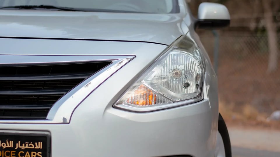 Used 2022 Nissan Sunny SV in Silver – Headlight Close-up for Sale at First Choice Cars Dubai Sharjah