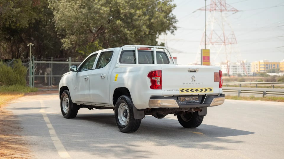 Used 2023 Peugeot Landtrek Double Cabin in White – Left Back Diagonal (45°) View for Sale at First Choice Cars Dubai Sharjah